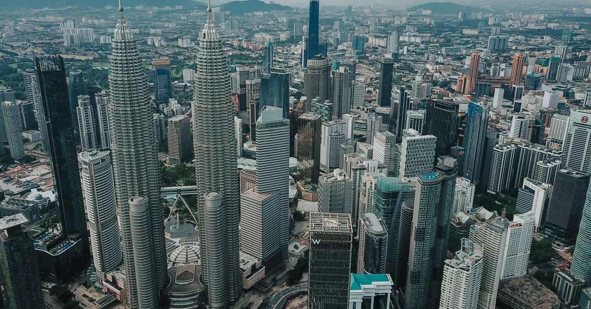 Aerial view Kuala Lumpur city with famous Petronas Twin Towers surrounded with glass skyscrapers and urban architecture