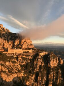 Rock formations and pine trees on the slopes of Montserrat mountain above the abbey