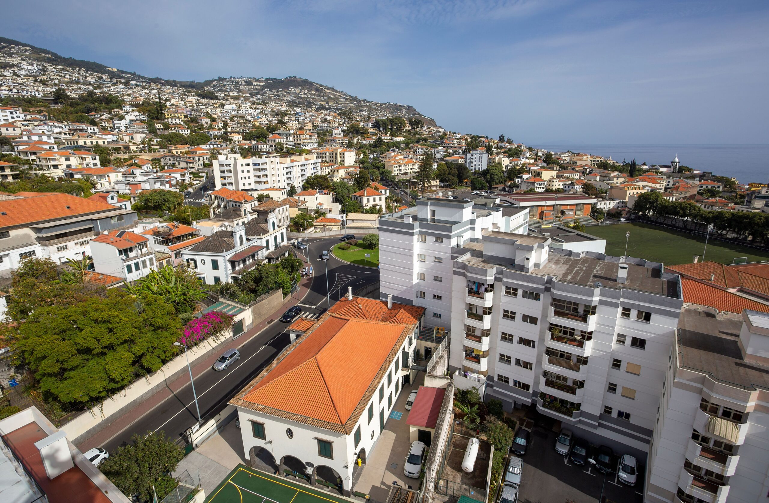 Aerial view of Funchal with red rooftops and the coastline
