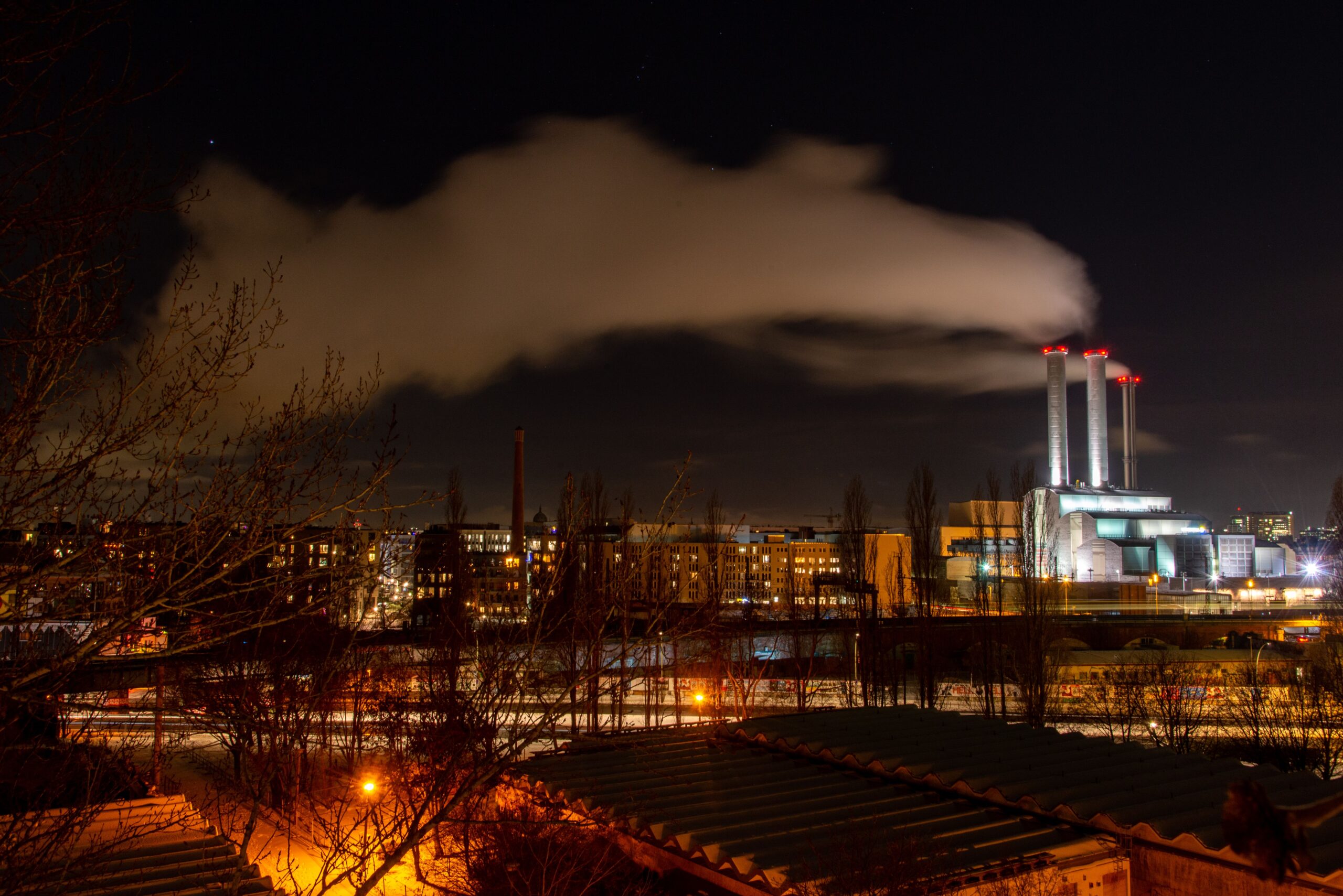 Industrial complex at night with a floodlit power station