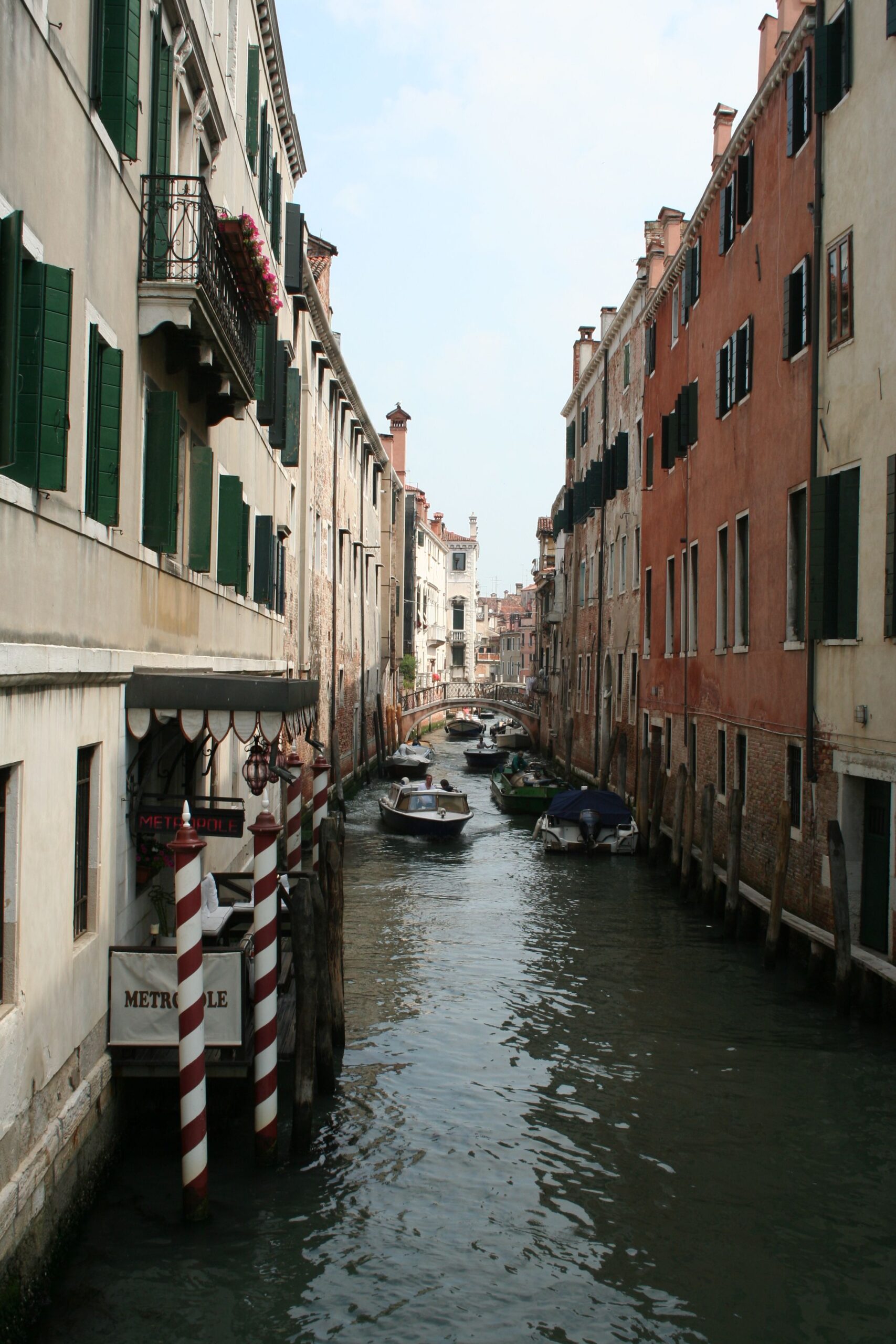 A Venetian canal with boats and historic architecture