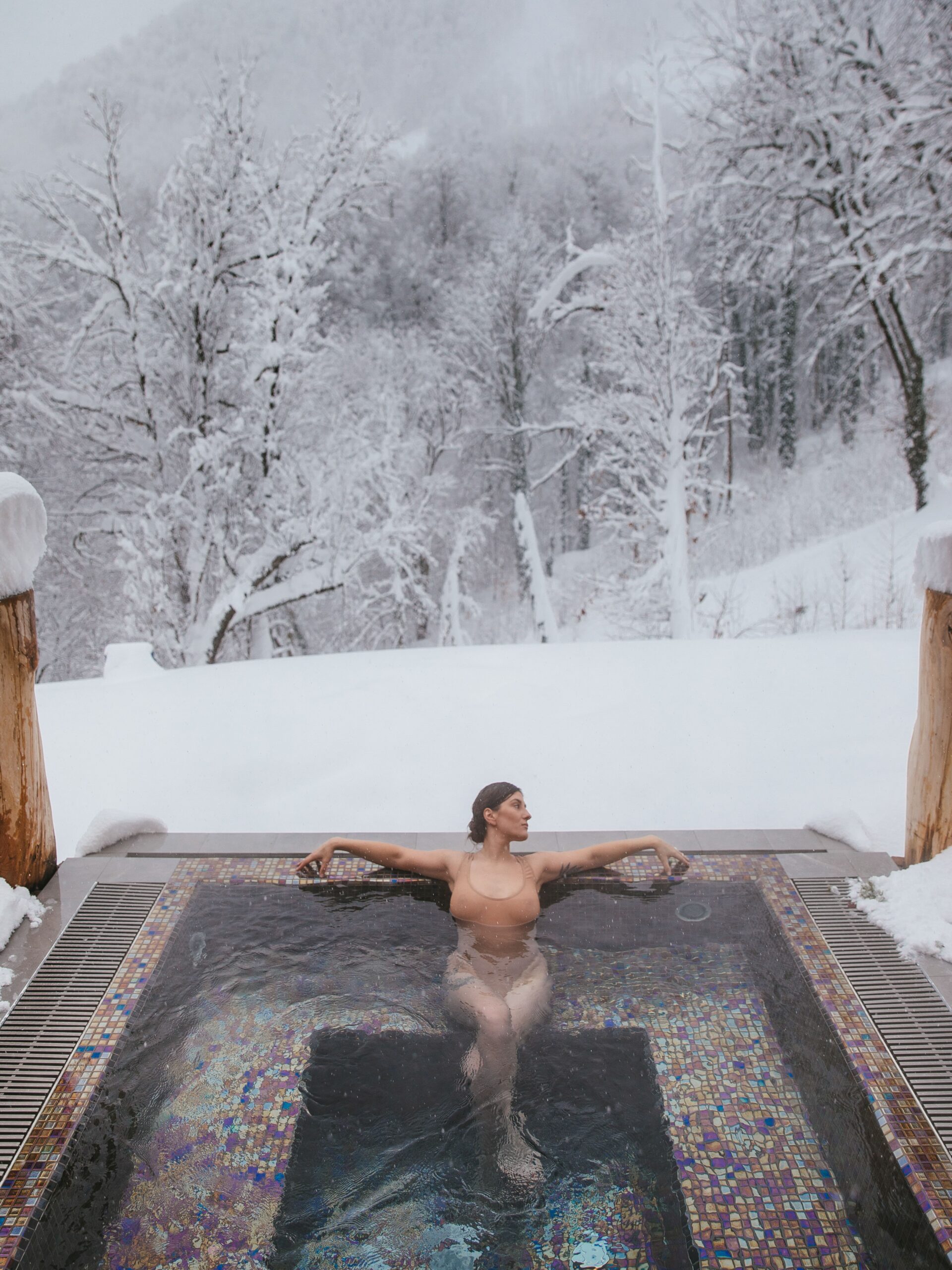 A hot thermal pool in a snowy forest