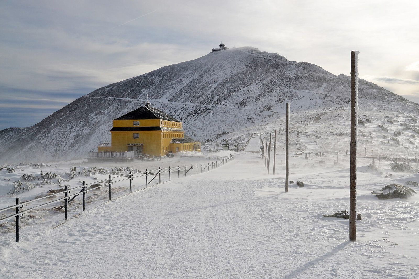 Snow-covered Śnieżka and the Dom Śląski hut in winter