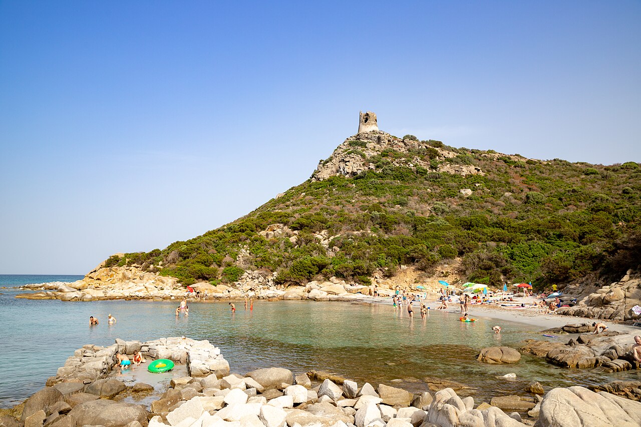 Porto Giunco beach near Villasimius with shallow water, granite boulders and a watchtower on the hill