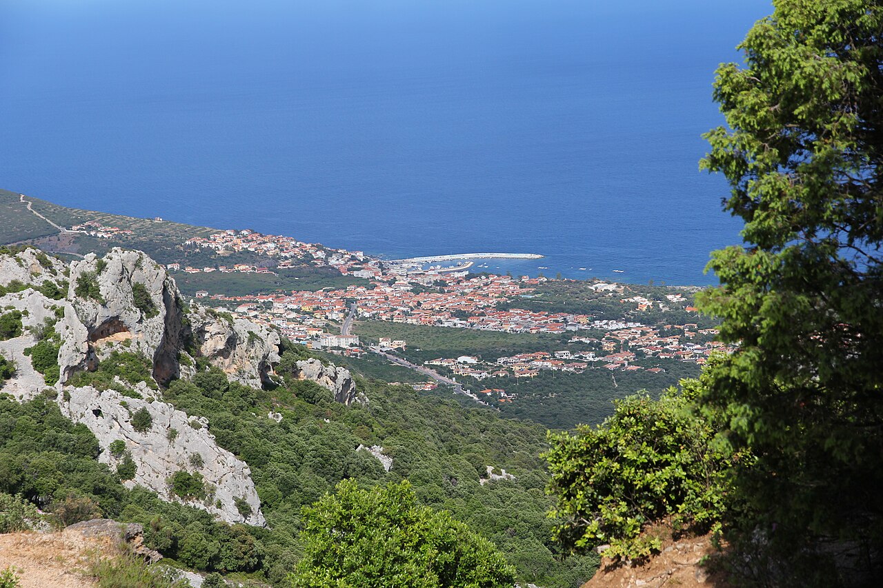 View from the mountains down to the village of Cala Gonone and the calm blue water of the Gulf of Orosei on Sardinia's east coast