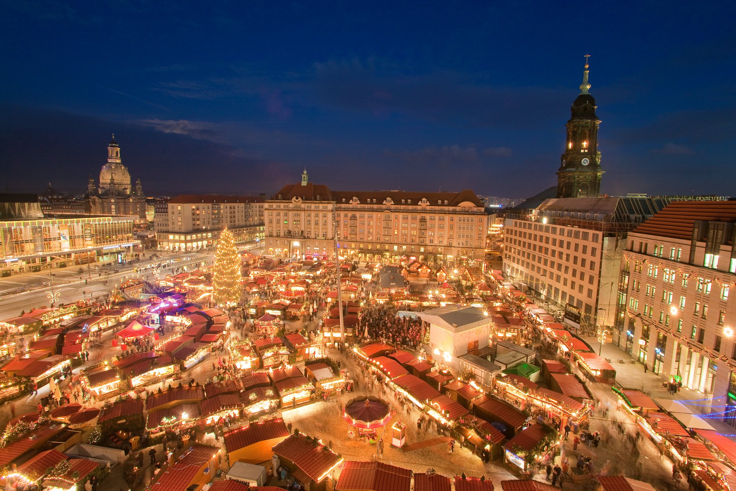 Dresden Christmas market: evening view from above of the Striezelmarkt on the Altmarkt, the Frauenkirche dome on the left and the Kreuzkirche tower on the right